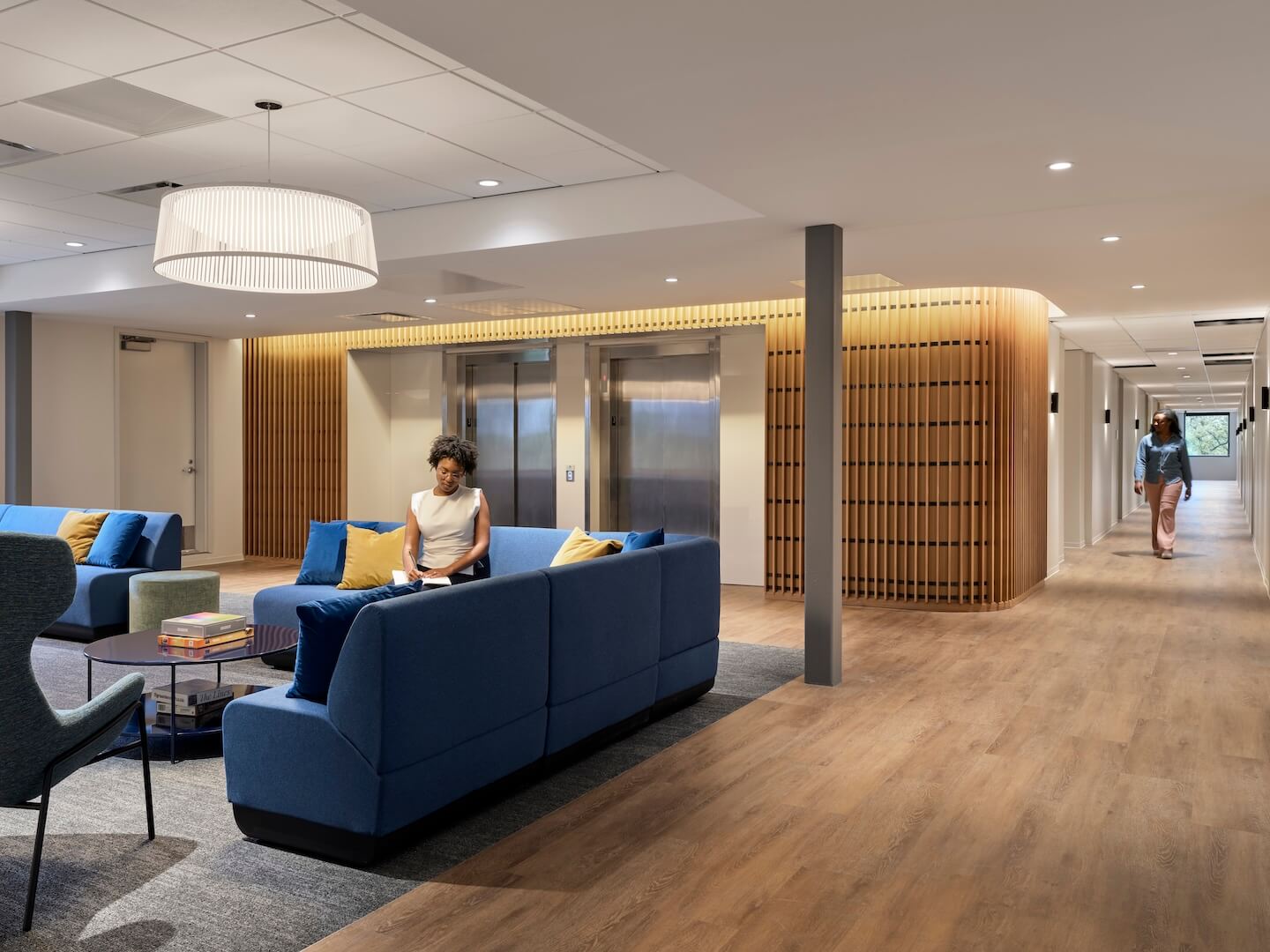 Trauma-informed design at Covenant House creates a calming space with wood tones, warm colors, and layered textures.