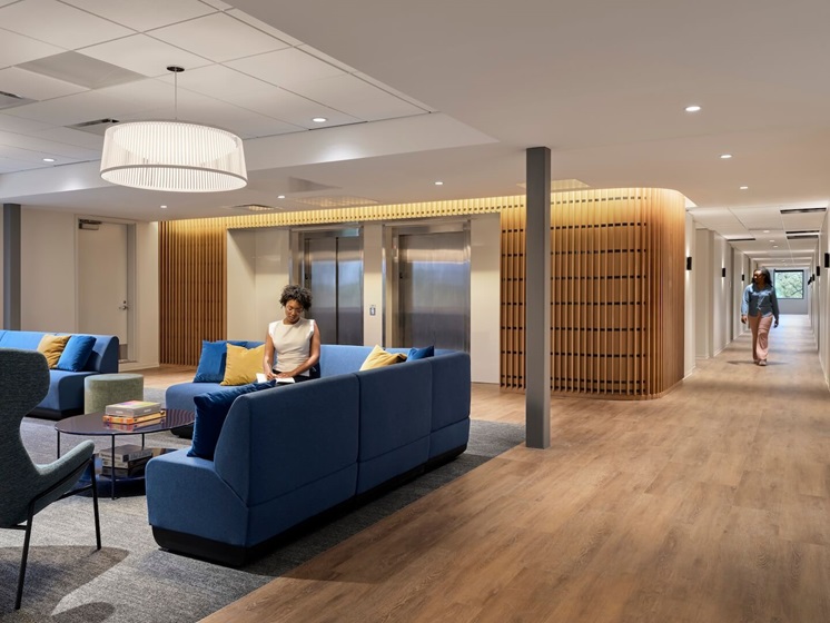Trauma-informed design at Covenant House creates a calming space with wood tones, warm colors, and layered textures.