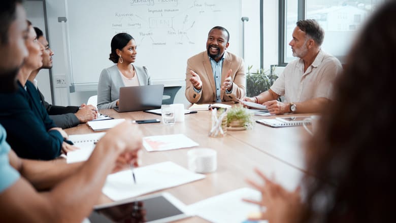 A group of coworkers chatting in a meeting