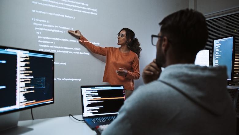 A woman leading a coding presentation.