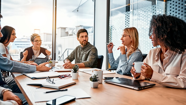 A group of business people sitting around a conference table.