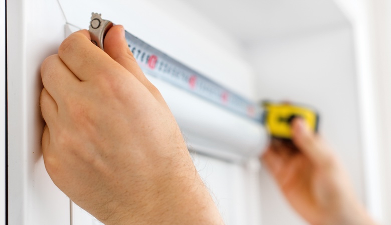 A man holding a tape measure