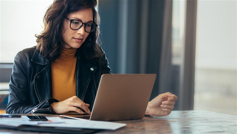 Lady with yellow shirt on with black glasses