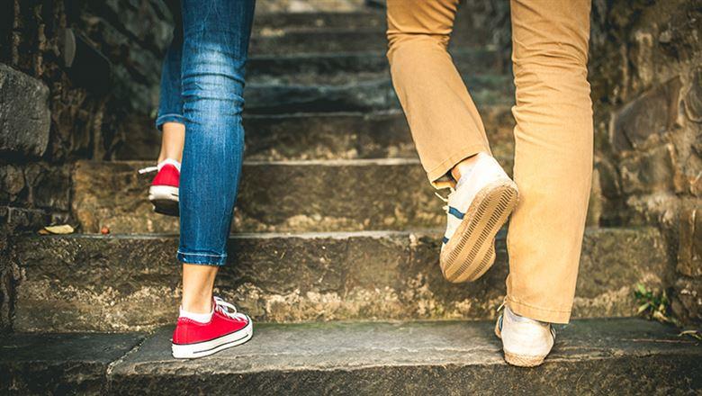 two people walking together up stone steps
