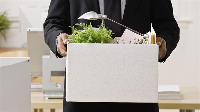 HR professional holding a box of office supplies