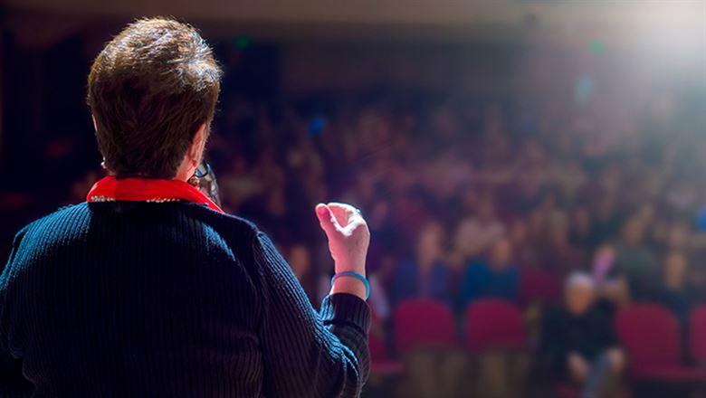 a professional speaking in front of a crowd