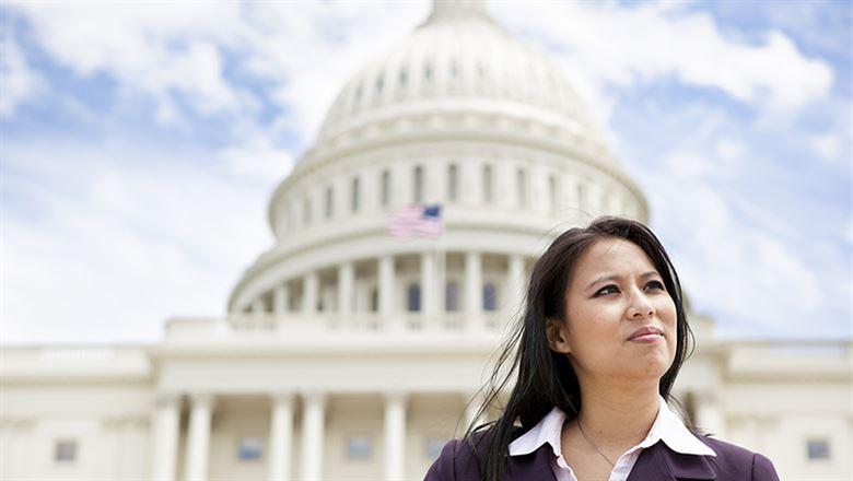 businesswoman standing in front of The U.S. Capitol