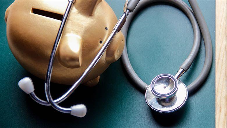 piggy bank next to a stethoscope