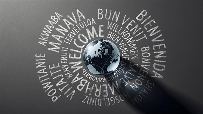 "welcome" written in different languages around a digital globe