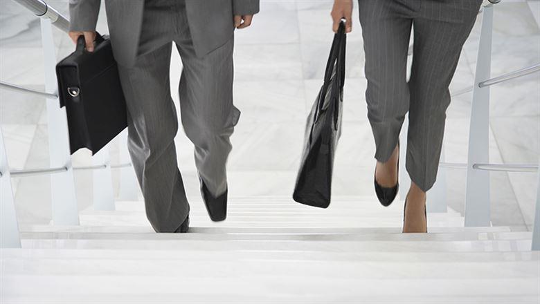 two business professionals walking up stairs