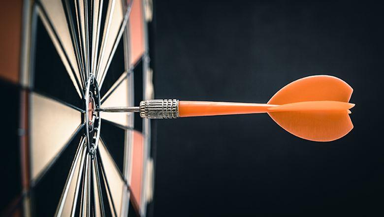 a dart hitting the bullseye target