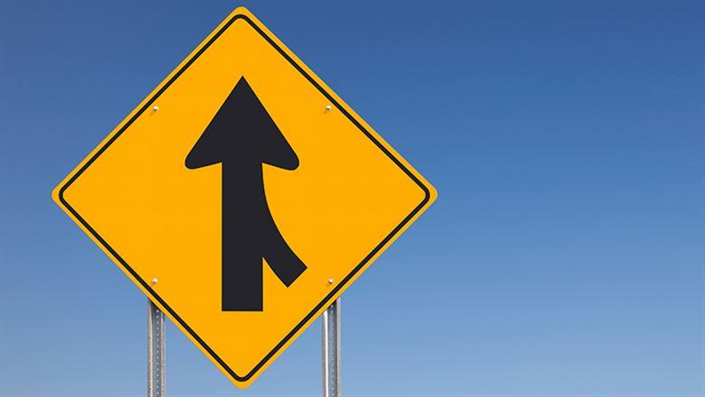 two arrows merging on road sign