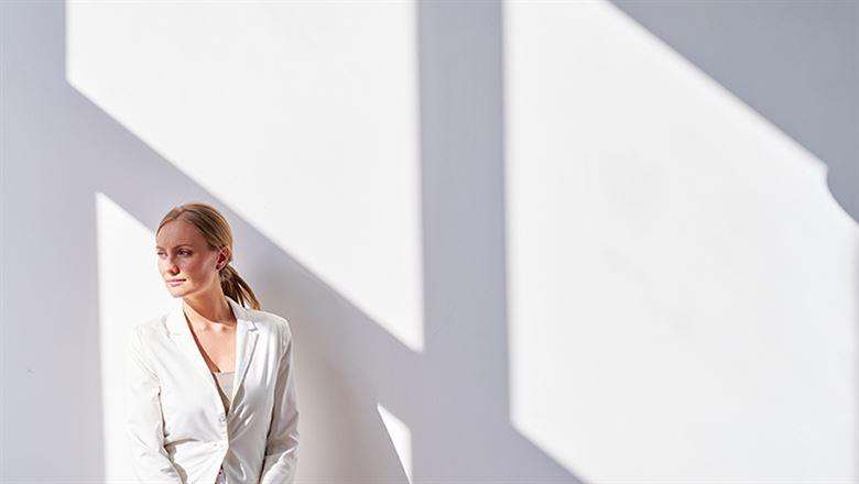 a woman standing alone in a corner