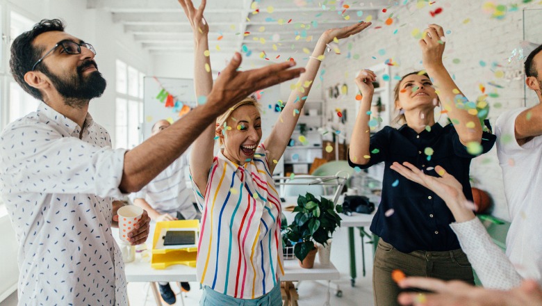 group of coworkers celebrating together in their office