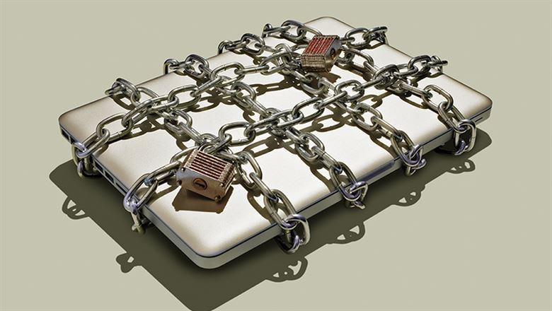 a laptop bound with chains and locks