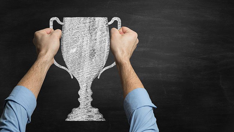 person holding a trophy or cup 