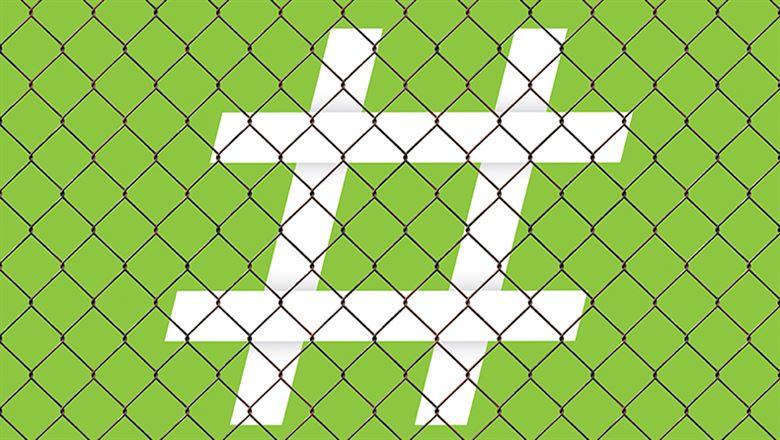 a large white hashtag behind a chainlink fence
