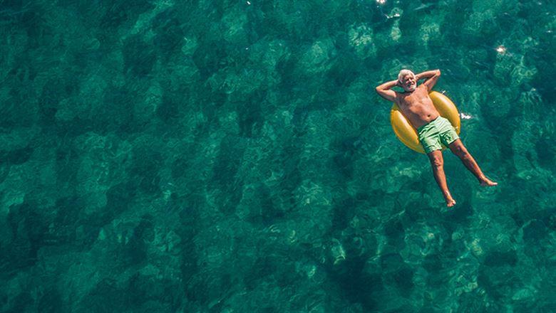 man relaxing on a floatie in a pool