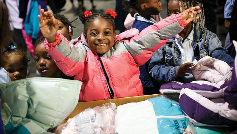 a happy young girl wearing a winter coat