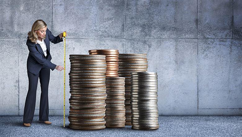 a professional measuring a stack of large coins
