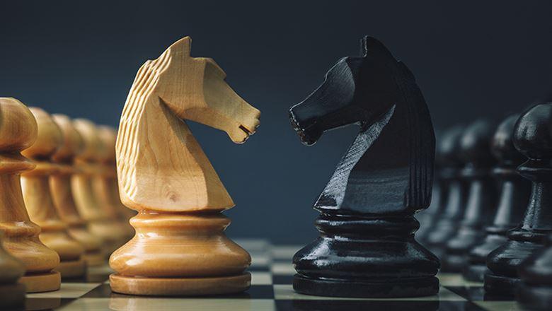 two chess pieces facing each other