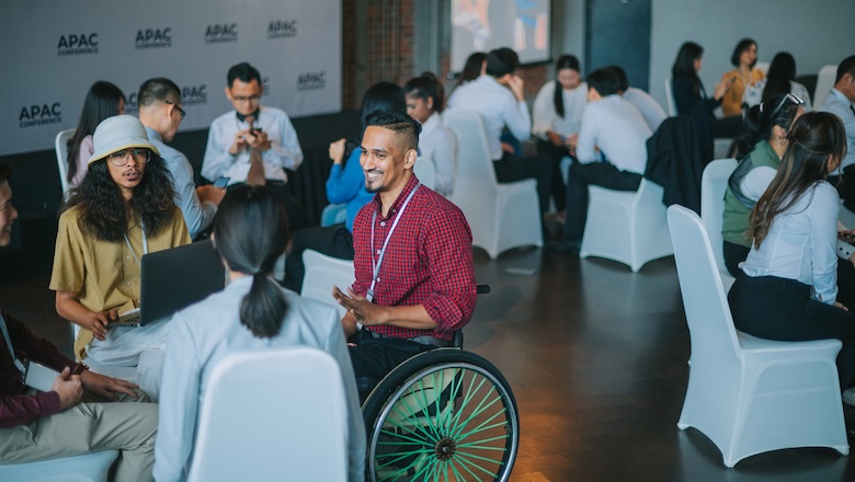 A man in a wheelchair at an event.
