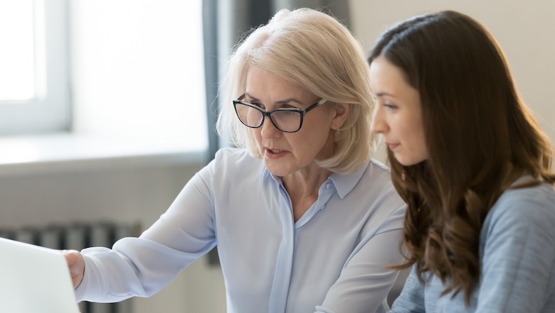 An older woman and younger woman working together
