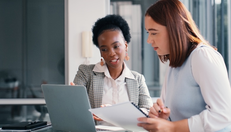 Two women talking on a laptop
