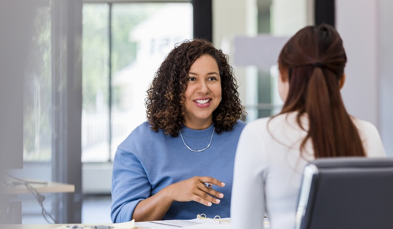 A humna resources employee talking to another employee.