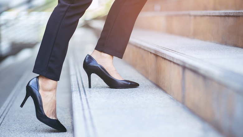 A woman in heels climbing the stairs.