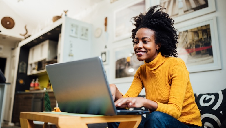 Happy African American woman working from home